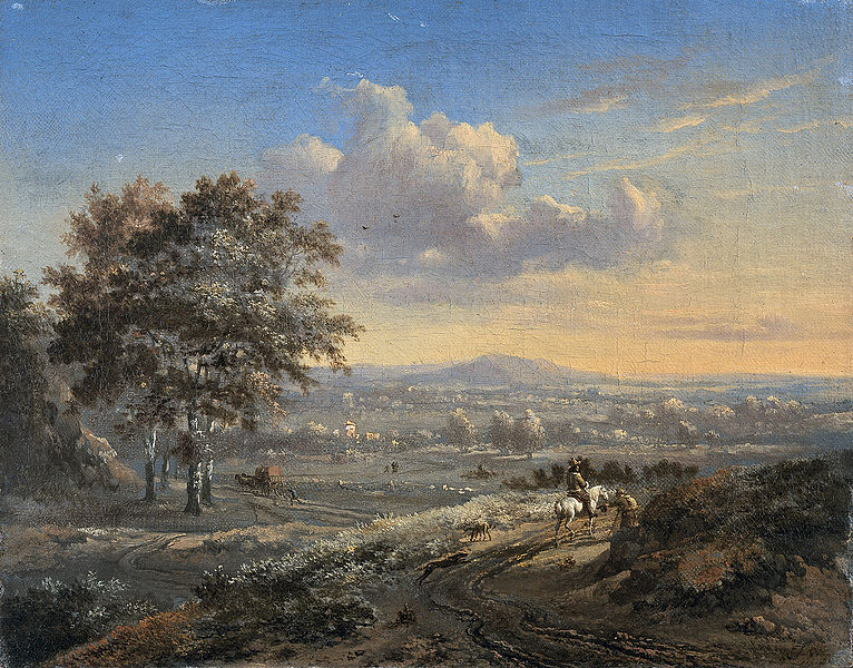 Hilly landscape with a rider on a country road.